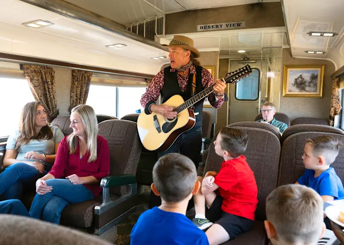 musician playing for families on the train